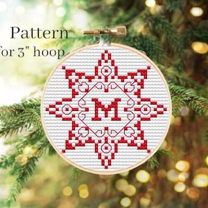 May include: A red and white cross-stitch pattern for a 3-inch hoop featuring a snowflake design with the letter "M" in the center.