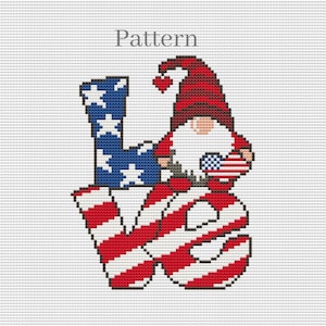May include: A cross-stitch pattern featuring the word "LOVE" in red, white, and blue stripes, with a gnome holding a small American flag heart in the center.