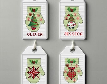 May include: Four white gift tags with green and red embroidered mittens. Each tag has a different design: a Christmas tree, a gnome, a snowflake, and a heart. The tags are labeled with the names Olivia, Jessica, Lucas, and Michael.