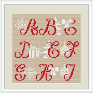 May include: Red embroidered letters spelling "Merry Christmas" with white snowflake, tree, gift, and ornament designs.