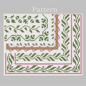 May include: A cross-stitch pattern featuring a white background with a decorative border of green leaves and small pink dots. The design includes a corner section with a tan and pink geometric frame, showcasing a repeating botanical motif.