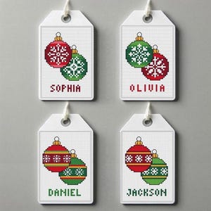 May include: Four white gift tags with red and green Christmas ornaments and names "Sophia", "Olivia", "Daniel", and "Jackson" written below.