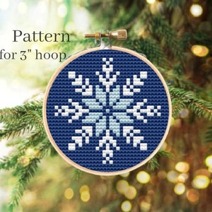 May include: A blue and white snowflake cross stitch pattern for a 3 inch hoop.