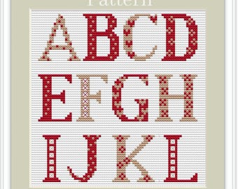 May include: Cross stitch pattern for the letters A through L. The letters are red with a beige polka dot pattern. The background is white.