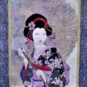 May include: A woman in a traditional Japanese kimono with a floral pattern, holding a fan and a wooden stick. She has dark hair and is wearing a red and white headband. The background is a light purple and white fabric with a floral pattern.