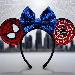 May include: Red and black Spider-Man themed Minnie Mouse ears with a blue sequined bow. The ears feature a spider web design and a spider silhouette.