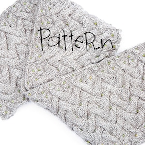 May include: Two gray knitted scarves with a cable knit pattern and green beads. The scarves are folded and the word "Pattern" is written in black across the top.