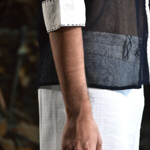 Made from 100% eco-friendly cotton and featuring open-mesh fabric, this shaman shirt ensures breathability and comfort in any setting, from bustling festivals to tranquil daily life