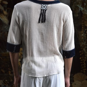 Made from 100% eco-friendly cotton and featuring open-mesh fabric, this shaman shirt ensures breathability and comfort in any setting, from bustling festivals to tranquil daily life.