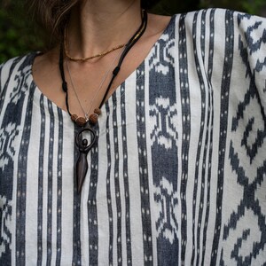 Handcrafted carved wood Artemis goddess amulet on a natural wood bead necklace, an ideal one-year anniversary gift symbolizing protection and shamanic tradition