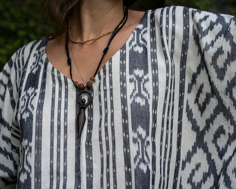 Handcrafted carved wood Artemis goddess amulet on a natural wood bead necklace, an ideal one-year anniversary gift symbolizing protection and shamanic tradition