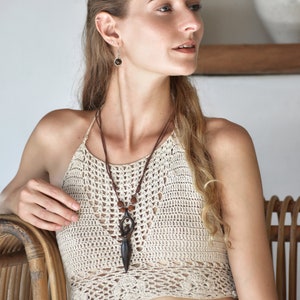 Handcrafted carved wood Artemis goddess amulet on a natural wood bead necklace, an ideal one-year anniversary gift symbolizing protection and shamanic tradition
