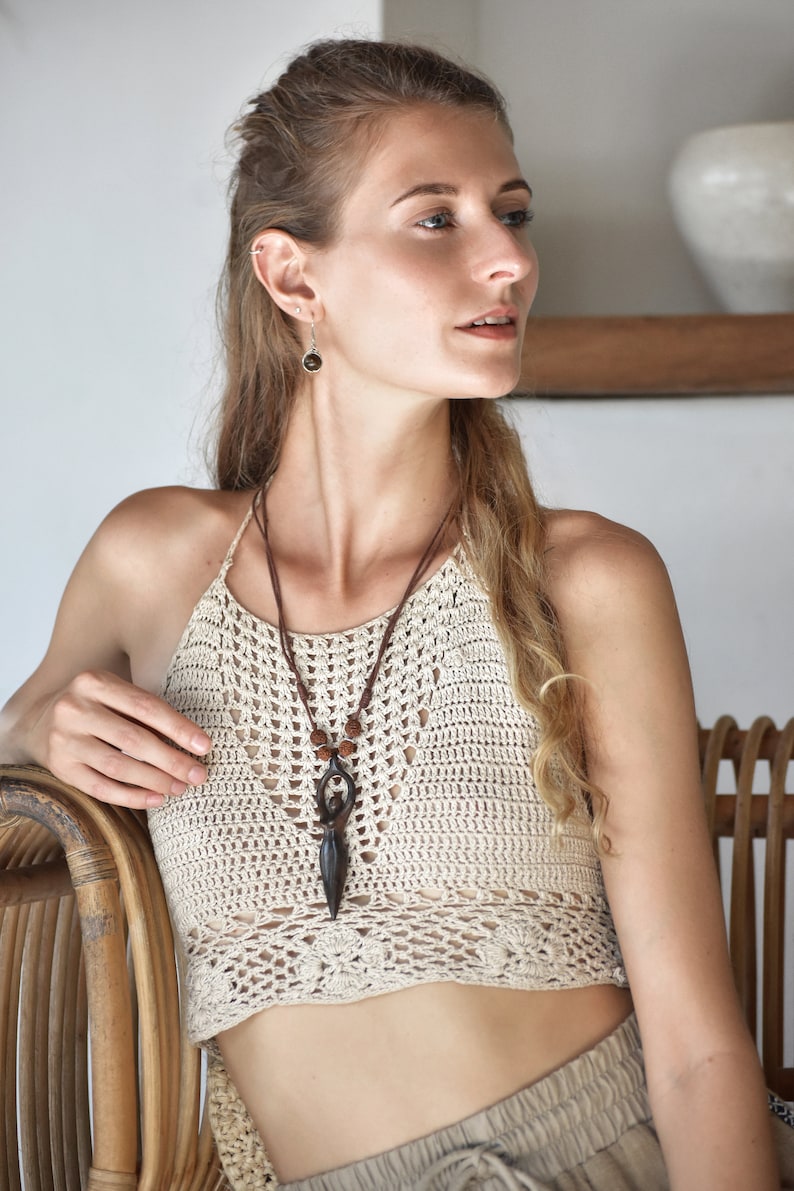 Handcrafted carved wood Artemis goddess amulet on a natural wood bead necklace, an ideal one-year anniversary gift symbolizing protection and shamanic tradition