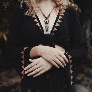 Handcrafted carved wood Artemis goddess amulet on a natural wood bead necklace, an ideal one-year anniversary gift symbolizing protection and shamanic tradition