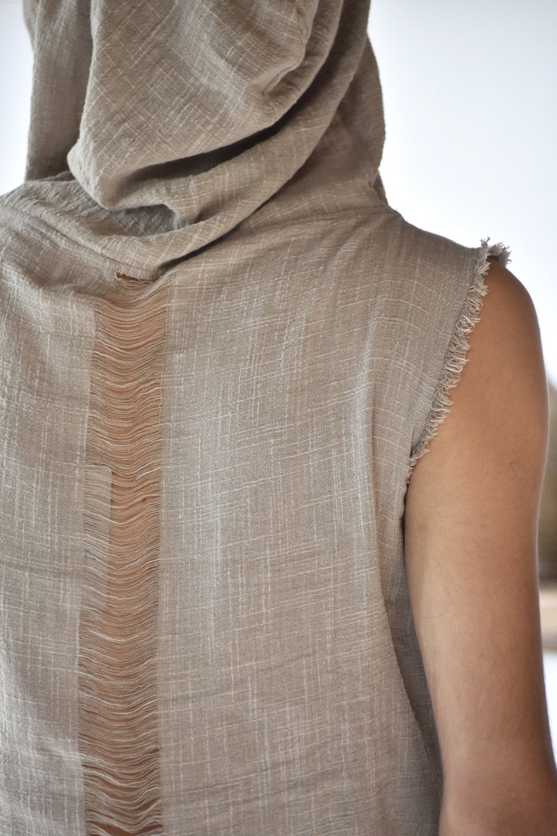 This grey hoodie jacket is a perfect blend of bohemian charm and shamanic essence, designed for those who appreciate the freedom of movement and the allure of tribal aesthetics.