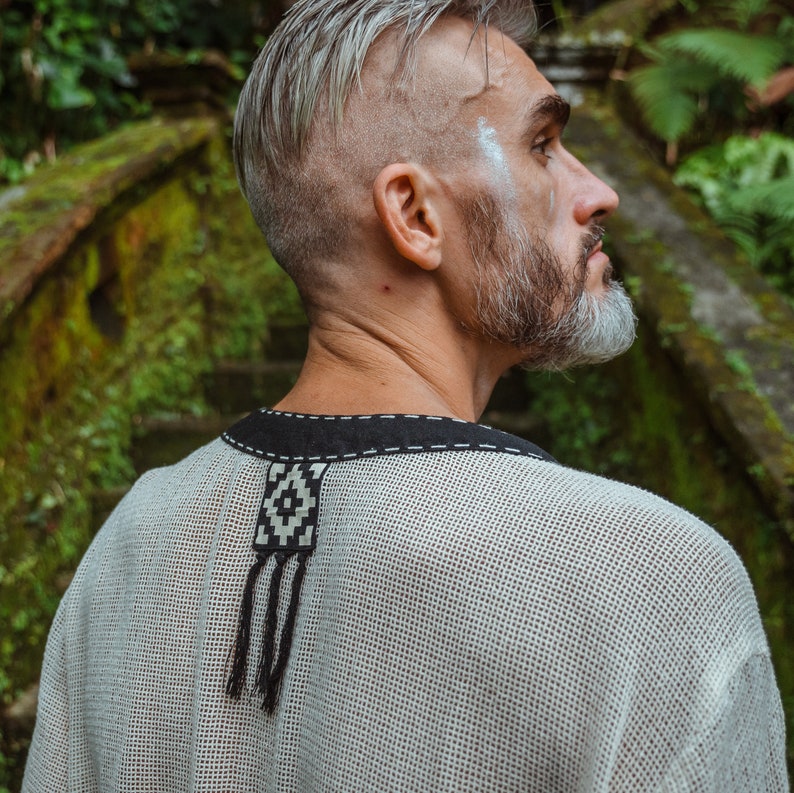 Made from 100% eco-friendly cotton and featuring open-mesh fabric, this shaman shirt ensures breathability and comfort in any setting, from bustling festivals to tranquil daily life.