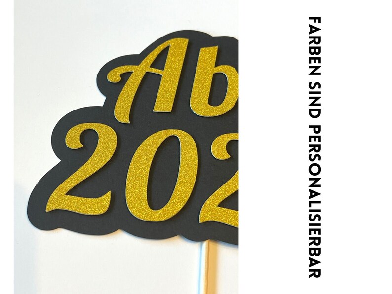May include: Black and gold glitter 'Ab 202' sign on a stick. The sign is perfect for a graduation party or celebration.