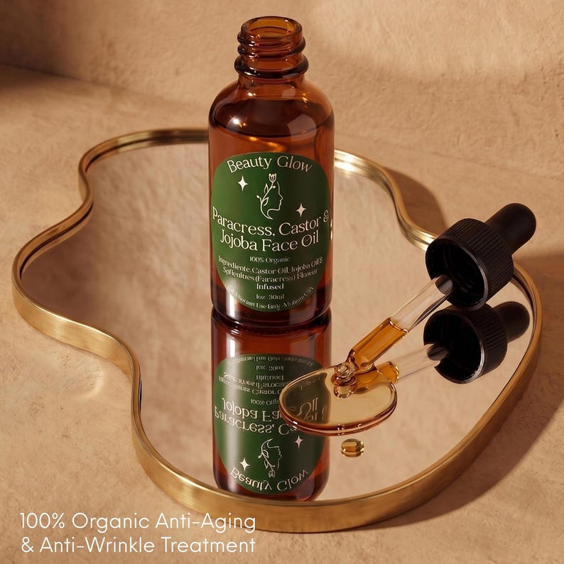 Pu&ograve; includere: Una bottiglia di vetro marrone di Beauty Glow Paracress, Castor & Jojoba Face Oil con un contagocce su uno specchio con bordo dorato. L'etichetta &egrave; verde con testo bianco e una silhouette. Il testo "100% Organic Anti-Aging & Anti-Wrinkle Treatment" &egrave; in basso.