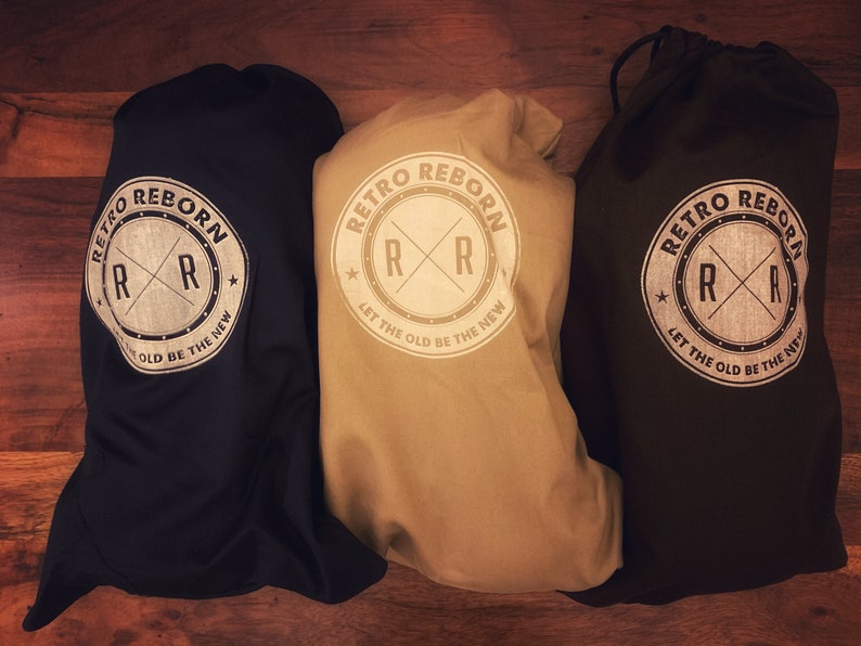 May include: Three drawstring bags in black, beige, and dark brown with a white logo that reads "Retro Reborn" and features a stylized "RR" with a star on either side. The logo also includes the text "Let the old be the new".