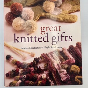 May include: A book cover titled "great knitted gifts" with the authors' names. The cover displays knitted items, such as pom-poms, a knitted glove, and a scarf. The colour scheme includes shades of brown, beige, and burgundy.