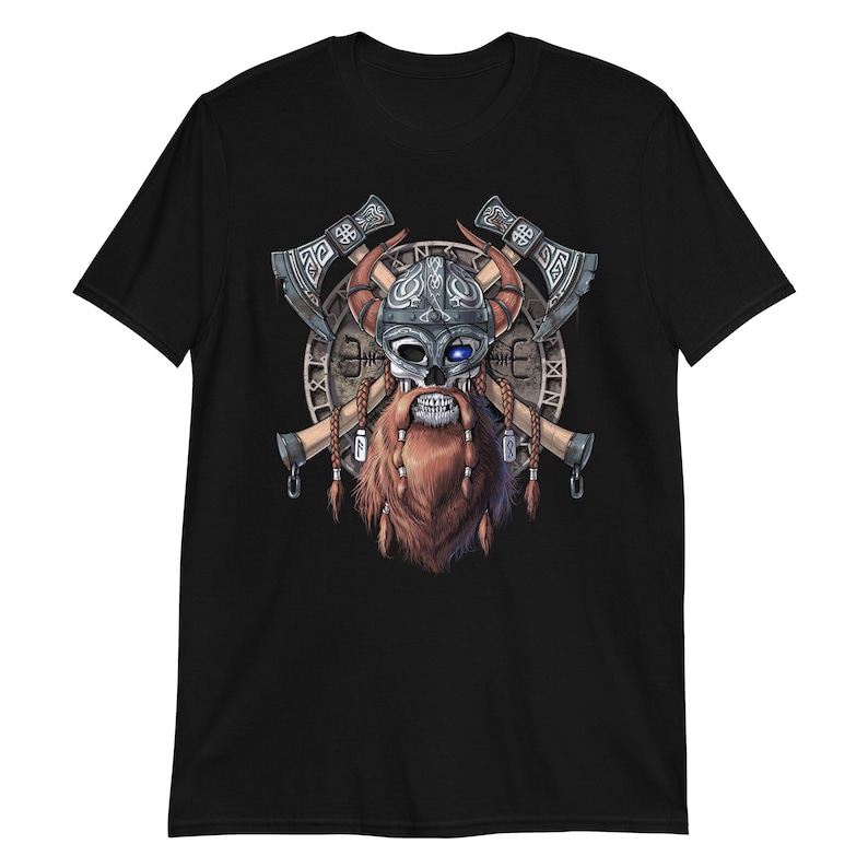 May include: Black t-shirt with a graphic of a skull wearing a horned helmet and a beard. The skull is surrounded by two crossed axes and a circular design.