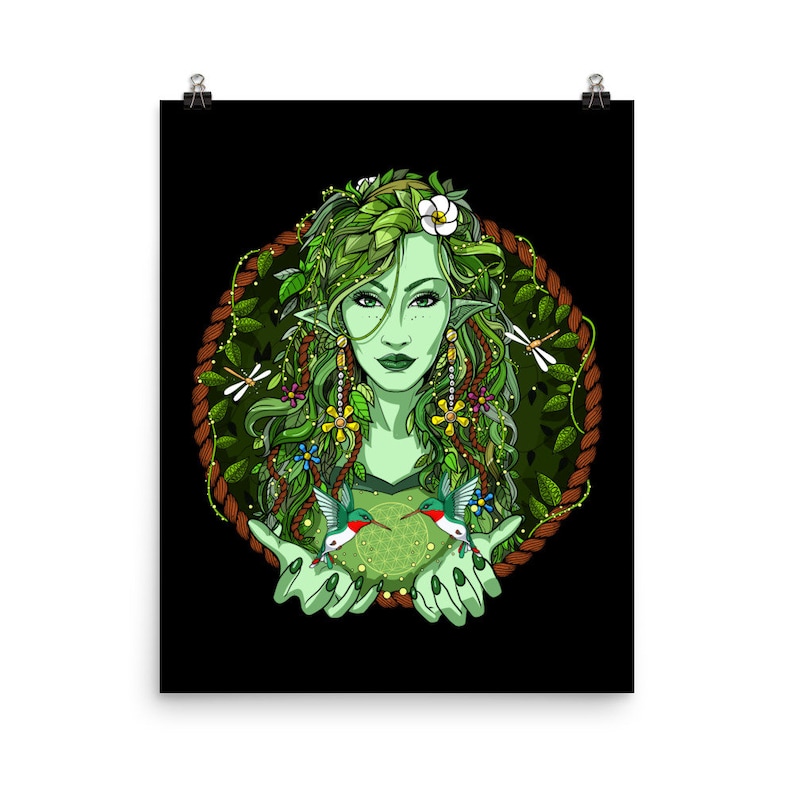 May include: A green-skinned woman with long green hair adorned with flowers and leaves. She is surrounded by a wreath of vines and has two hummingbirds in her hands. The background is black.
