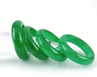 May include: Four jade green rings stacked on top of each other. The rings are smooth and polished.