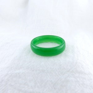 May include: A simple green ring made of smooth, polished jade.
