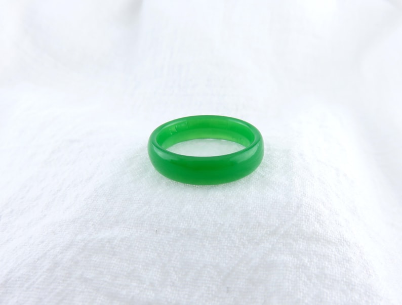 May include: A simple green ring made of smooth, polished jade.