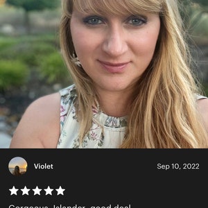 May include: A woman with blonde hair and blue eyes is smiling at the camera. She is wearing earrings with white flower designs. The image includes a review with the text "Gorgeous, Islander, good deal. I want to use it everyday."
