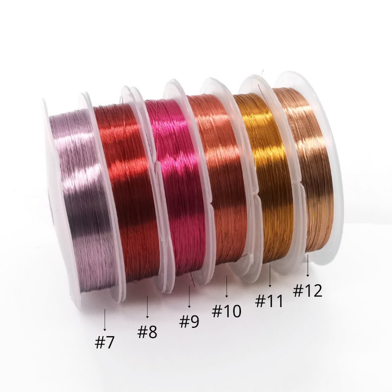 May include: Six spools of metallic wire in various colors, including silver, copper, pink, gold, and bronze. The spools are labeled with numbers 7 through 12.