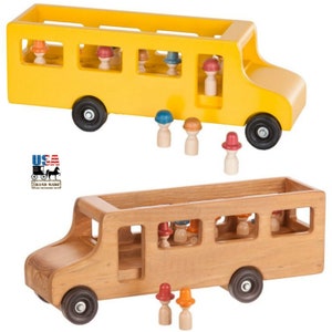 May include: Two wooden toy school buses, one yellow and one natural wood, with small wooden figures with hats. The figures can be placed inside the buses or outside.  The buses have wheels and are made in the USA.