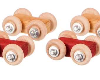 May include: Four wooden toy cars with wheels. Two cars have natural wood bodies and two cars have red bodies.