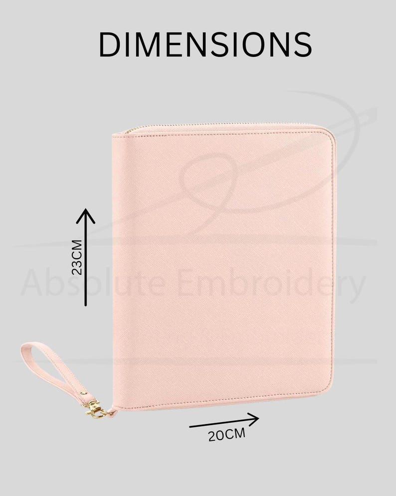 May include: A light pink zippered portfolio case with a matching wrist strap. The case features a textured surface and is labelled with the dimensions 23cm in height and 20cm in width. The text DIMENSIONS and Absolute Embroidery are visible.