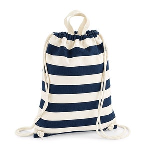 May include: A navy blue and white striped drawstring backpack. The bag features thick horizontal stripes, a drawstring closure, and a loop handle at the top. The drawstring is made of a thick, off-white rope.