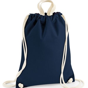 May include: A navy blue drawstring backpack with cream-colored rope straps. The bag is made of a smooth fabric and has a simple, minimalist design. The drawstring closure is visible at the top, and the straps are knotted at the bottom.