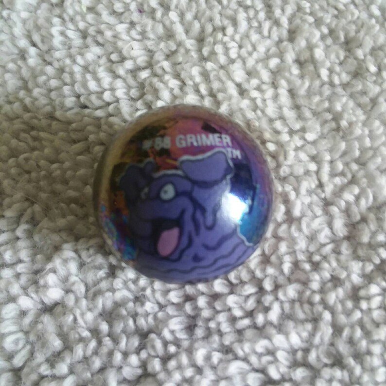 Pokemon marbles #88 Grimer holo foil metallic glass marble shooter in mint to mint plus condition