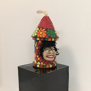 Bird Lover&#39;s head peeking out of a colorful  wooden bird house.