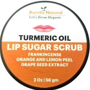 May include: A circular container with a white top and orange base, labelled "TURMERIC OIL LIP SUGAR SCRUB." Ingredients listed include frankincense, orange and lemon peel, and grape seed extract. The container is 56 gm.