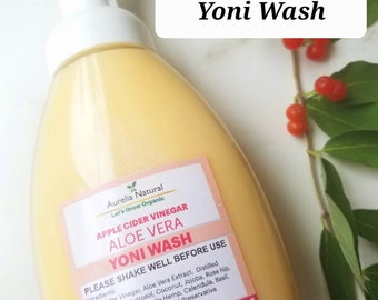 May include: A clear plastic bottle with a white pump dispenser filled with a yellow liquid. The bottle label is white with black text that reads "Aurelia Natural Let's Grow Organic Apple Cider Vinegar Aloe Vera Yoni Wash Please Shake Well Before Use Ingredients: Apple Cider Vinegar, Aloe Vera Extract, Distilled Steamed Rose Hydrosol, Coconut, Jojoba, Rose hip, Cucumber Extract, Castile Hemp, Calendula, Basil, Lavender, Frankincense, Natural Preservative 250 ml".