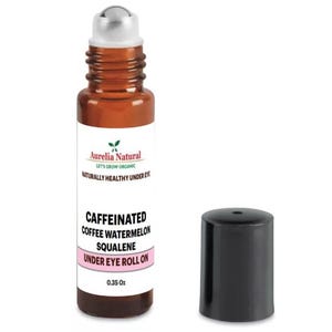 May include: A brown glass bottle with a rollerball applicator. The bottle is labelled "Aurelia Natural Let's Grow Organic Naturally Healthy Under Eye Caffeinated Coffee Watermelon Squalene Under Eye Roll On 0.35 Oz".
