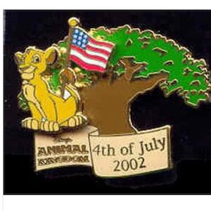 May include: A commemorative pin featuring Simba from The Lion King, an American flag, and a tree. The pin includes the text "Animal Kingdom" and "4th of July 2002". The pin is yellow, red, blue, green, and brown.