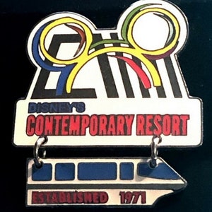 May include: A white and black pin with a yellow Mickey Mouse head with colorful swirls. The pin says "Disney's Contemporary Resort" and "Established 1971" with a small white monorail underneath.