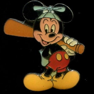 May include: A cartoon Mickey Mouse wearing a blue baseball cap and holding a brown baseball bat. He is wearing red shorts with yellow buttons and yellow shoes.