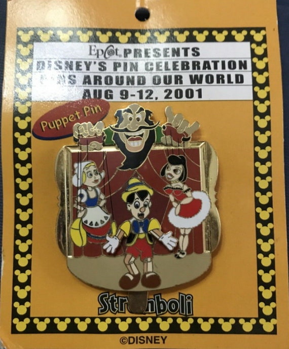 ディズニーの悪役ストロンボリが人形ピノキオ WDW ピンをカードに持っ
