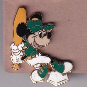 May include: A Mickey Mouse baseball pin. The pin features Mickey Mouse in a green baseball uniform and cap, holding a yellow baseball bat. The pin has white gloves and shoes. The pin is outlined in gold.