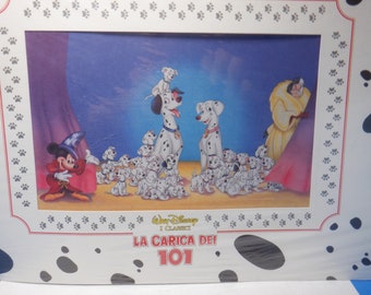 May include: A framed illustration of the Disney movie 101 Dalmatians. The image shows the Dalmatian parents, Pongo and Perdita, surrounded by their 101 puppies. Mickey Mouse, dressed as a magician, is in the foreground. The title of the movie, "LA CARICA DEI 101", is printed below the image.