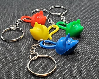 Llavero con pieza de juego de trampa para ratones reciclada