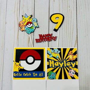 May include: Two Pokemon themed party favor boxes. The box on the left has a red and white Pokeball with the text "Gotta Catch 'Em All". The box on the right has a yellow background with black stripes and the name "Hayley" in black letters. Both boxes have images of Pokemon characters.