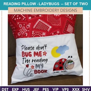 May include: A reading pillow with a red bandana print top and a white pocket. The pocket features embroidered text "Please don't BUG ME I'm reading MY BOOK" with a ladybug and a sun and cloud design.